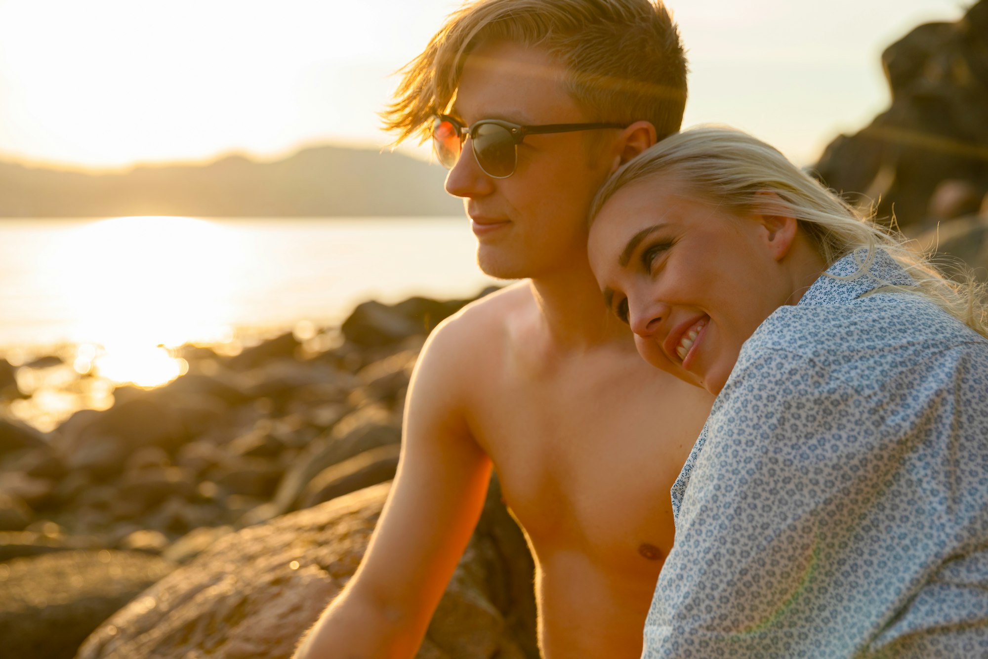 Smiling Woman Sitting With Boyfriend At Beach